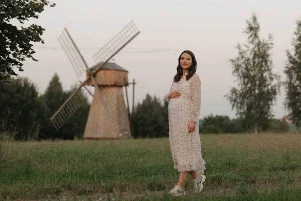 Pregnant Woman Windmill Background Holding Her Belly Her Hand While — Stock Photo, Image