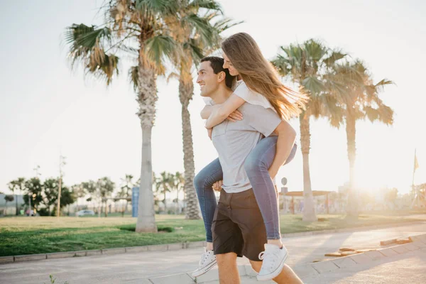 Kind Brunette Girl Riding Her Hispanic Boyfriend Palms Sunlight Rays — Stock Photo, Image