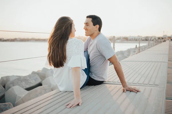 Hispanic Man Smiling Brunette Girl Sitting Staring Each Other Breakwater — Stock Photo, Image