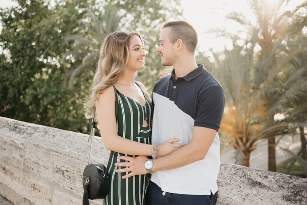 Girl Green Dress Hugging Her Boyfriend Ancient Bridge Sunset Old —  Fotos de Stock