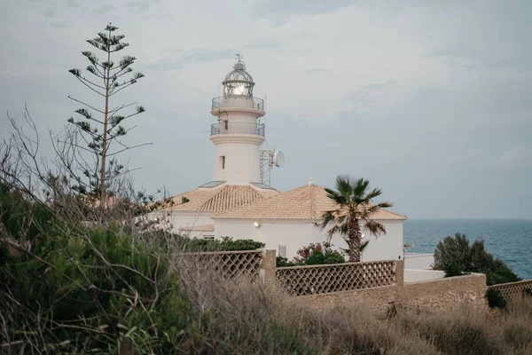 The lighthouse with the sea in the background in the highland park at sunset in Valencia.