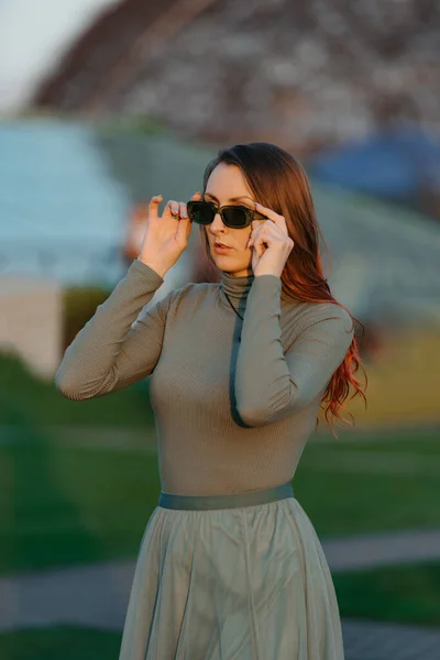 Redhead Woman Green Clothes Checking Her Sunglasses Park Sunset — Stock Photo, Image