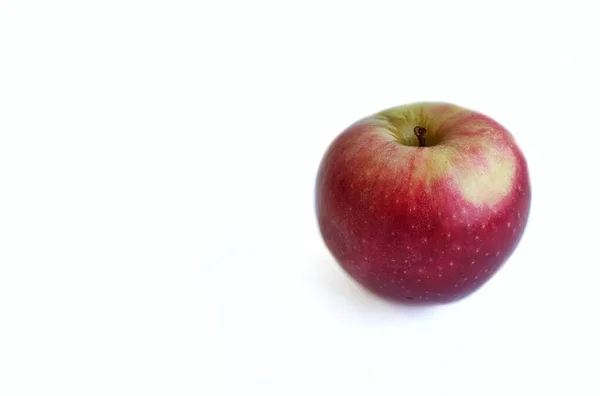 Ett rött äpple på vit bakgrund, minimalistisk isolat — Stockfoto