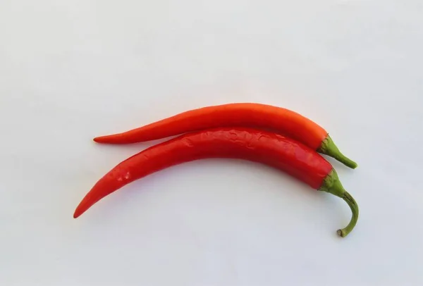 Two red hot peppers on a white background — Stock Photo, Image