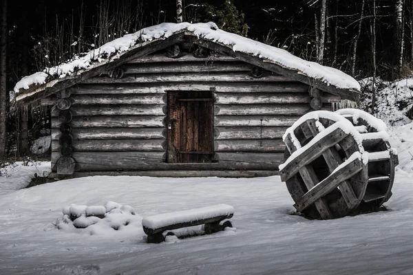 İsveç 'te kışın soğuk İsveç' te, çimen çatılı eski bir kereste kulübesi.