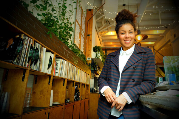 Proud female owner and entrepreneur in her cafe 