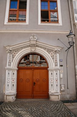 Goerlitz, Saksonya, Almanya, 04 Eylül 2021: antik Rönesans portalı, çiçekli süsler, güneşli yaz gününde eve giriş, sıva ve heykellerle dolu tarihi bina cephesi, ahşap oymalı kapılar..