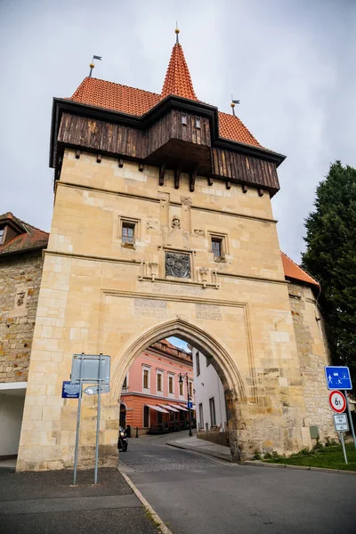 Louny, Çek Cumhuriyeti, 19 Eylül 2021: Duvarı ve prizmatik kaleleri olan Zatec Kapısı, sonbahar günü çatısı altında ahşap koridor bulunan ortaçağ takviye kompleksi, ön cephede Latince yazılar
