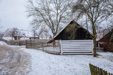 Kourim, Central Bohemia, Czech Republic, 26 December 2021: Traditional rural village wooden house in winter, historic country-style architecture, Christmas in Skanzen, open-air ethnographic museum