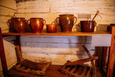 Kourim, Bohemia, Czech Republic, 26 December 2021: Interior of Traditional village house, barn with agricultural tools, troughs and clamps, country-style architecture, open-air ethnographic museum