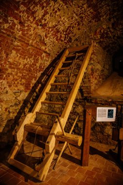 Cheb, Western Bohemia, Czech Republic, 14 August 2021: Gothic stone castle, medieval historic fortress or stronghold, torture room, wooden rack in old medieval chamber 