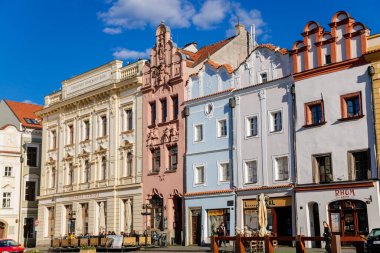Pardubice, Czech Republic, 17 April 2022: Main Pernstynske square with townhall, colorful renaissance and baroque historical buildings with towers in medieval center at sunny summer day