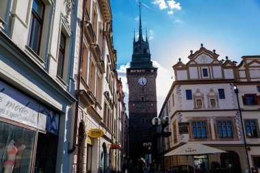 Pardubice, Czech Republic, 17 April 2022: Main Pernstynske square with townhall, colorful renaissance and baroque historical buildings with towers in medieval center at sunny summer day, Green gate