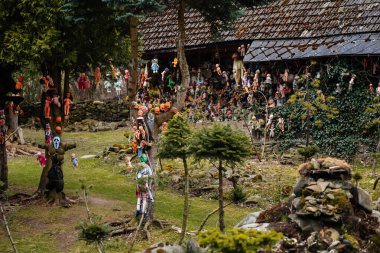 Rvacov near Hlinsko, Czech Republic, 15 April 2022: House of Hanging Dolls, terrible dirty bad plastic dolls hang on trees and on walls, Halloween and horror scary place, Abandoned and lonely toy