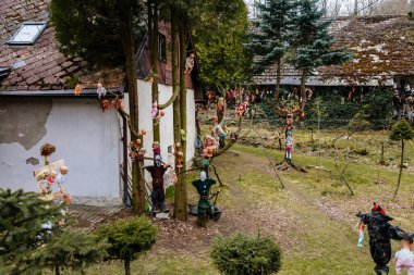 Rvacov near Hlinsko, Czech Republic, 15 April 2022: House of Hanging Dolls, terrible dirty bad plastic dolls hang on trees and on walls, Halloween and horror scary place, Abandoned and lonely toy
