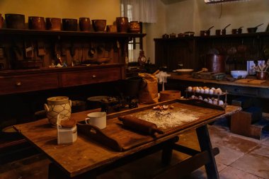 Slatinany, Czech Republic, 17 April 2022:  Castle chateau representative interior with baroque wooden carved furniture, Antique house, kitchen with ceramic tiled stove, crockery, jugs and pans