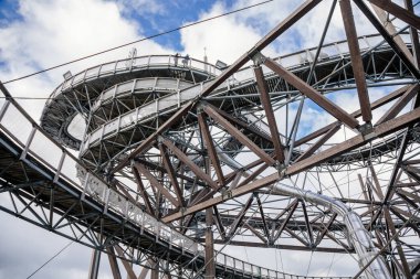 Dolni Morava, Czech Republic, 16 April 2022: Path in the clouds, tourist attraction with spiral platform to observation tower, landscape with forest and sky on mountains, Skywalk with snow