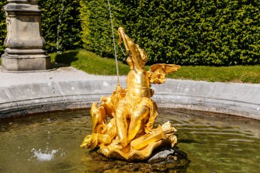 Linderhof Palace, Ettal, Bavaria, Germany, 3 July 2022: Schloss or chateau at rococo style surrounded by gardens and parks, castle built by King Ludwig II based on Versailles, golden angel fountain