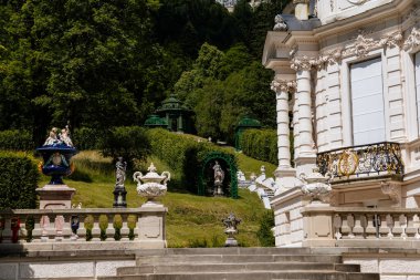 Linderhof Palace, Ettal, Bavaria, Germany, 3 July 2022: Schloss or chateau at rococo style surrounded by gardens and parks, castle built by King Ludwig II based on Versailles, sunny summer day