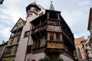 Colmar, Alsace, France, 4 July 2022: town capital of Alsatian wine, narrow picturesque street with medieval colorful houses, Timber framing or post-and-beam construction, romantic city at summer day