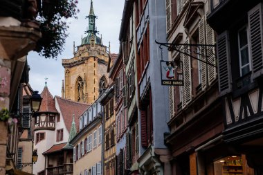 Colmar, Alsace, France, 4 July 2022: town capital of Alsatian wine, narrow picturesque street with medieval colorful houses, Timber framing or post-and-beam construction, romantic city at summer day