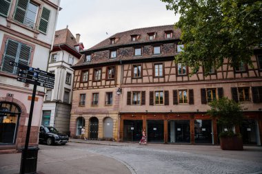 Colmar, Alsace, France, 4 July 2022: town capital of Alsatian wine, narrow picturesque street with medieval colorful houses, Timber framing or post-and-beam construction, romantic city at summer day