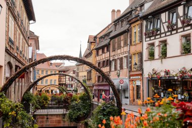 Colmar, Alsace, France, 4 July 2022: town capital of Alsatian wine, narrow picturesque street with medieval colorful houses, Timber framing or post-and-beam construction, Little Venice with channels