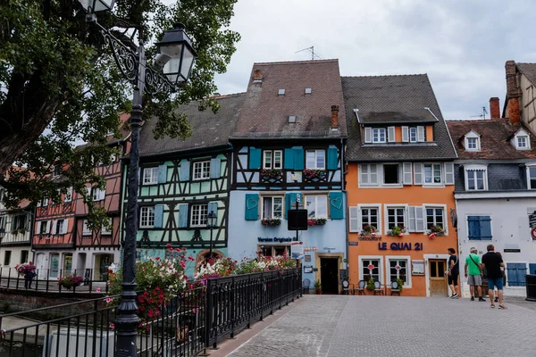 Colmar, Alsace, France, 4 July 2022: town capital of Alsatian wine, narrow picturesque street with medieval colorful houses, Timber framing or post-and-beam construction, Little Venice with channels