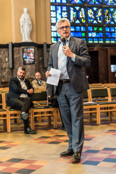 Schaerbeek, Brussels - Belgium - 04 26 2019 - Mayor Bernard Clerfayt speeching to a crowd during the event around the renovation og the Saint Suzanna art deco church