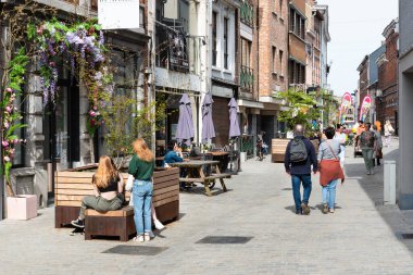 Diest, Limburg, Belgium - 11 04 2022 - Teenage girls and couple walking through the commercial street of old town
