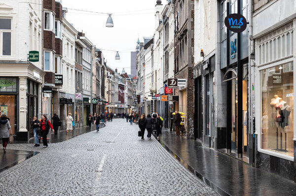 Maastricht, Limburg, The Netherlands -04 04 2022 - People walking in the rainy streets of old town