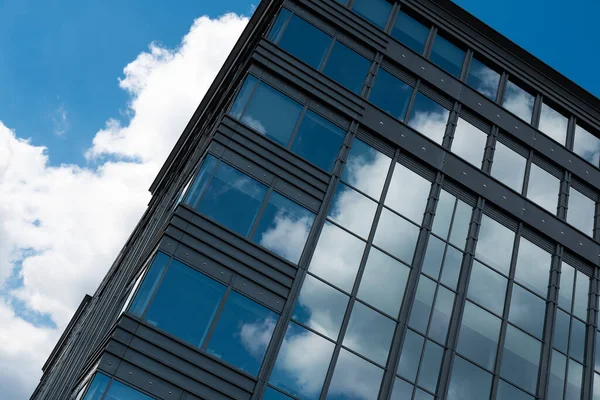 stock image Boitsfort, Brussels Capital Region - Belgium - 05 20 2020 Blue clouds reflecting in the windows of a high rise office building at Boulevard du Souverin