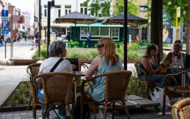 Mechelen, Antwerp Eyaleti, Belçika - 06 04 2022 - Eski bir kasabada terasta konuşan iki kadın