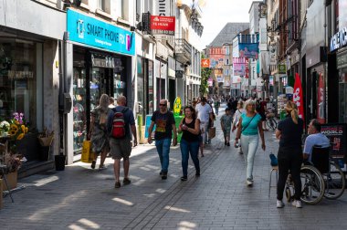 Mechelen, Antwerp Province- Belgium, 07 08 2022 - People walking through the Bruul shopping street in old town