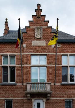 Wuustwezel, Antwerp Province, Belgium - 07 08 2022 - Facade of the town hall and Flemish flag