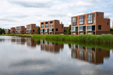 Breda, North Brabant, The Netherlands, 08 09 2022 - Residential apartment blocks reflecting in the river