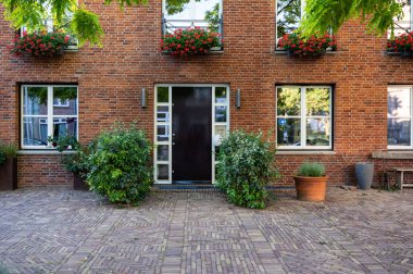Zaltbommel, Gelderland, The Netherlands - 07 12 2022 - Traditional house facades with pottery and plants