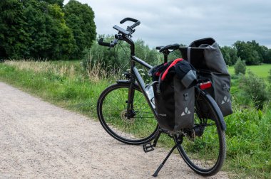 Ochten, Gelderland, The Netherlands - 07 12 2022  Trekking bike standing on a cyclist trail at the dyke of the River Waal