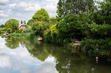 Tiel, Gelderland, The Netherlands, 07 14 2022 - Reflecting nature in the water of the River Ligne