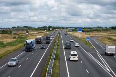 Tiel, Gelderland, The Netherlands, 07 14 2022 - Traffic on the A15 highway, high angle view