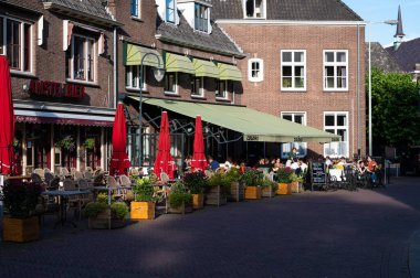 Wageningen, Gelderland, The Netherlands, 07 11 2022 Old village square with people in restaurants and terraces