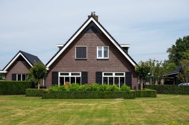 Harskamp, Gelderland, The Netherlands - 07 14 2022 - Country house with front yard, surrounded by trees