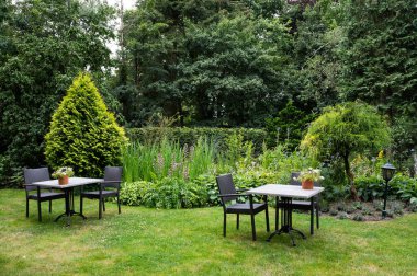 Hattem, Gelderland, The Netherlands, 07 14 2022 - Chairs and tables of a terrace in the woods