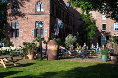 Zwolle, Overijssel, The Netherlands, 07 15 2022 - Students enjoying the sun at the medieval buildings