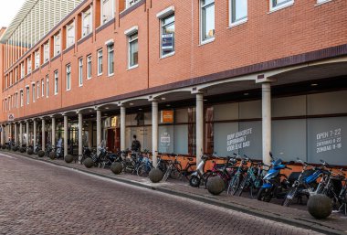 Zwolle, Overijssel, The Netherlands, 07 15 2022 - Facade of the Coop supermarket with a row of parked bicycles