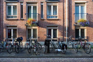 Zwolle, Overijssel, The Netherlands, 07 15 2022 - Historical brick stone facade with a row of parked bikes