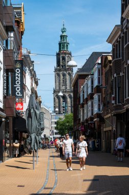 Groningen, The Netherlands, 07 20 2022 - Young people walking through the commercial streets of old town