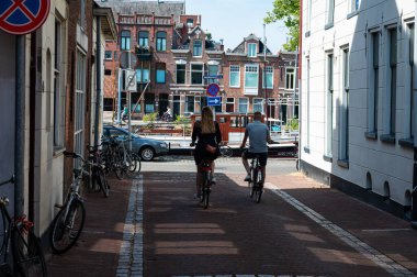 Groningen, The Netherlands, Young couple driving through the str
