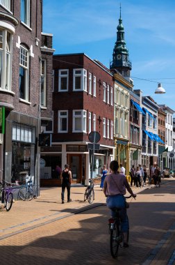 Groningen, The Netherlands, 07 20 2022 - Students driving the bicycle through the streets of old town