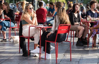 Ixelles, Brüksel - Belçika - 10 09 2018 Belga Kraliçesi Flagey 'de güneşli bir terasta içki içen gençler